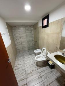 a bathroom with two toilets and a sink at Apartamentos Siete Cavas in Bahía Blanca