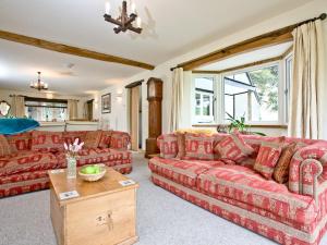 ein Wohnzimmer mit roten Sofas und einem Tisch in der Unterkunft Exmoor View in Barbrook