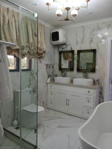 a bathroom with two sinks and a shower at Vaj in Lagos