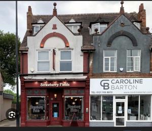 a building with two arched windows on a street at #81 Stylish Top Floor - for 2 - 10 mins to Brueton Park - " Perfect for Business Traveler and Couple - Free Parking" in Shirley