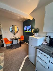 a kitchen with a refrigerator and a table with a mirror at #81 Stylish Top Floor - for 2 - 10 mins to Brueton Park - " Perfect for Business Traveler and Couple - Free Parking" in Shirley