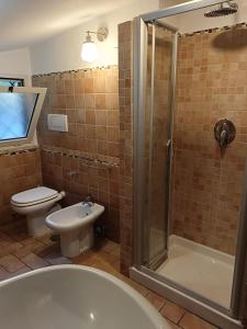 a bathroom with a shower and a toilet and a sink at Casa Mille Lire in Ciampino +19 photos