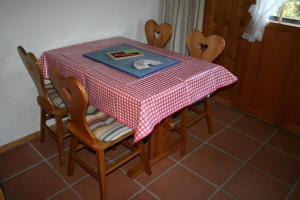 a table with a red and white checkered table cloth at Fewo Mit Herz in Horboden