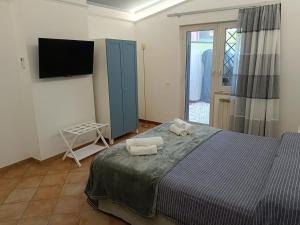 a bedroom with a bed with two towels on it at Casa Mille Lire in Ciampino