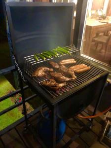 einen Grill mit Fleisch und Würstchen drauf in der Unterkunft Tidenest Cottage in Nuwara Eliya + 9 Fotos