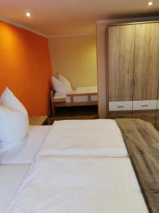 ein Schlafzimmer mit einem großen weißen Bett und einem Schrank in der Unterkunft Gästewohnung Eschefeld in Frohburg