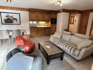 a living room with a couch and a table at Superbe Appartement 4P 6 Pers avec Piscine et Parking à Méribel - FR-1-180-598 in Les Allues +7 photos