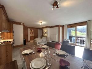 a kitchen and living room with a table with wine glasses at Superbe Appartement 4P 6 Pers avec Piscine et Parking à Méribel - FR-1-180-598 in Les Allues