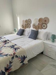 a bedroom with a bed with hats on the wall at La casa del mar in Zahara de los Atunes