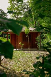 a wooden cabin in the woods with trees at Pousada Ocean Garden in Antonina +4 photos