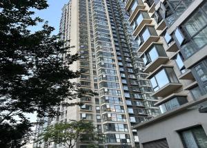 a tall apartment building with many windows at Annie Apartment 2105 in Kunming