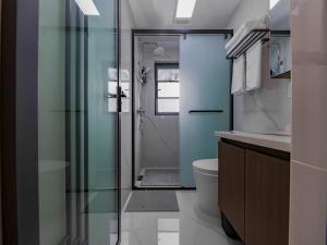a bathroom with a glass shower and a toilet at Annie Apartment 2105 in Kunming +43 photos