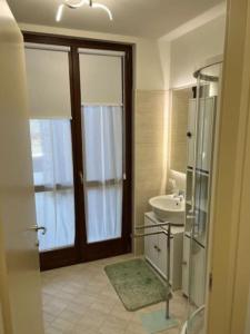 a bathroom with a shower and a sink and a toilet at Maison Poluc - Petit Bijou in Champoluc +18 photos