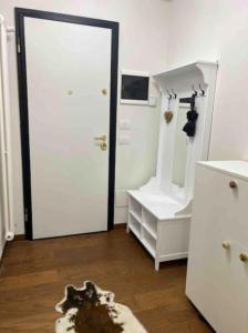 a room with a white door and a mirror at Maison Poluc - Petit Bijou in Champoluc