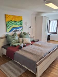 a large bed in a bedroom with a painting on the wall at Turistična kmetija Sušek in Muta