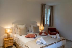 a bedroom with a large bed with towels on it at Château de l'insolas in Villeneuve-lès-Avignon +69 photos