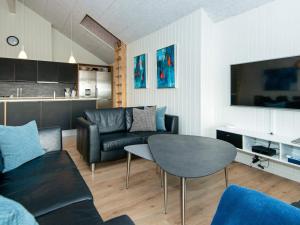 a living room with a couch and a table at 5 star holiday home in Ebeltoft in Ebeltoft