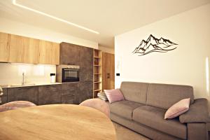 a living room with a couch and a table at Guest House Cemin in Predazzo