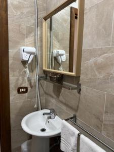 a bathroom with a sink and a mirror at Hotel Federico II in Naples +52 photos