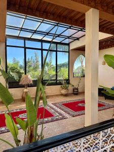 a large living room with a large glass window at Villa Atika in El Bougaria