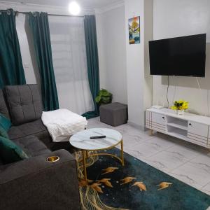 a living room with a couch and a fish tank at Ladivah Homes in Thika