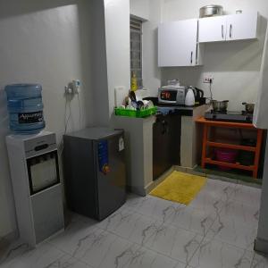 a kitchen with a stove and a refrigerator at Ladivah Homes in Thika +7 photos