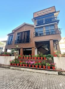 a building with potted plants in front of it at Shradha luxury room in Calangute