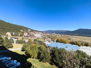 a view of a city with a town and a road at Nid des Angles - Cœur de station vue Lac & Montagne in Les Angles +2 photos