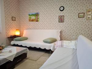 a room with two beds and a clock on the wall at Elato apartment in Florina