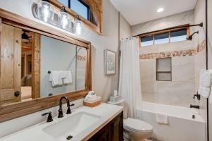 a bathroom with a sink and a toilet and a mirror at Banner Bear in Banner Elk +27 photos