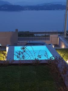 a swimming pool with a view of the ocean at night at I CARCIONI Infinity Pool in Belgirate +26 photos