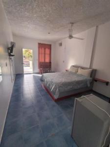 a bedroom with a bed and a tv in it at Apartamentos grigri in Río San Juan