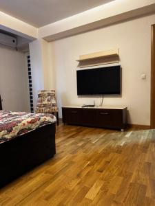 a bedroom with a flat screen tv on a wall at Old Town 33 in Sarajevo +7 photos