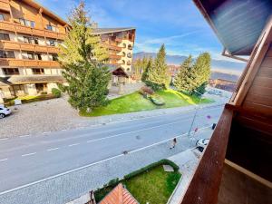 a view of a street from a window of a building at Todorini Kuli Apartments in Bansko