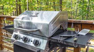 a grill sitting on a table with a spatula at Wooded Nest, Cozy 3BR Chalet Near Spas, Downtown Berkeley Springs & Hiking in Berkeley Springs