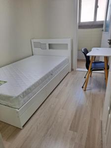 a bedroom with a bed and a table and a chair at 인천인하우스 