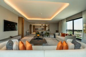 a living room with a white couch and a living room at MOVENPICK HOTEL AL ZAYTOON BAGHDAD in Baghdad