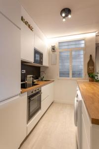 a kitchen with white appliances and a wooden counter top at New Bilbao city center in Bilbao +16 photos
