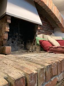 a brick fireplace with pillows sitting on it at I CARCIONI Infinity Pool in Belgirate