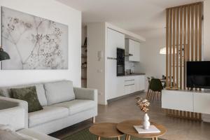 a living room with a couch and a table at Casa Vistalago Mountain Lake Iseo Hospitality in Bossico