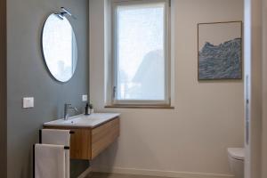 a bathroom with a sink and a window at Casa Vistalago Mountain Lake Iseo Hospitality in Bossico