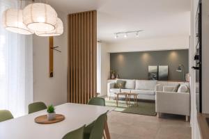 a living room with a white table and a couch at Casa Vistalago Mountain Lake Iseo Hospitality in Bossico