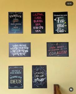 a wall with signs hanging on a wall at Recanto Monte das Oliveiras Hotel e Pousada in Tupim +3 photos