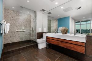 a bathroom with a sink and a shower and a toilet at The Gallery Loft - Downtown finest in San Diego