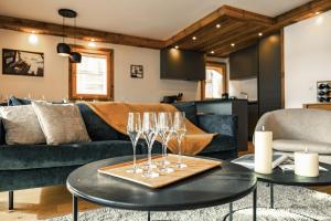 a living room with wine glasses on a table at Centre Les Gets with 2 parking and Slope views - 6&2 ppl - Asteria in Les Gets
