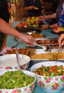 a group of people preparing food in bowls on a table at mountains wadi rum in Disah