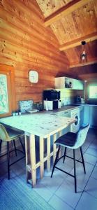 a kitchen with a large wooden table and chairs at Chalet L' Aventurière in Masevaux