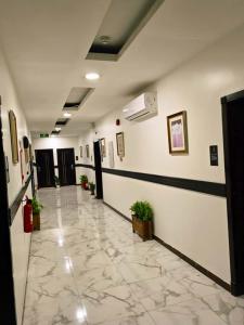 a hallway of a hospital with a tile floor at دلة الفال للشقق المخدومة in Dammam