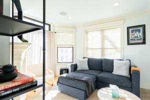 a living room with a blue couch and a table at Brownstone Luxury Penthouse Condo in Boston +42 photos