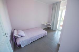 a bedroom with a bed and a table and a window at Villa Miranda in Ortona +35 photos